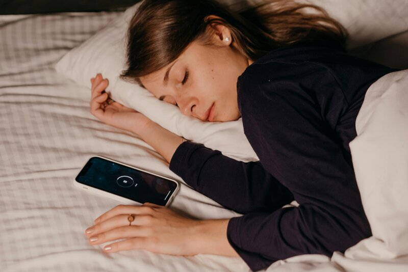 Woman sleeping by her phone